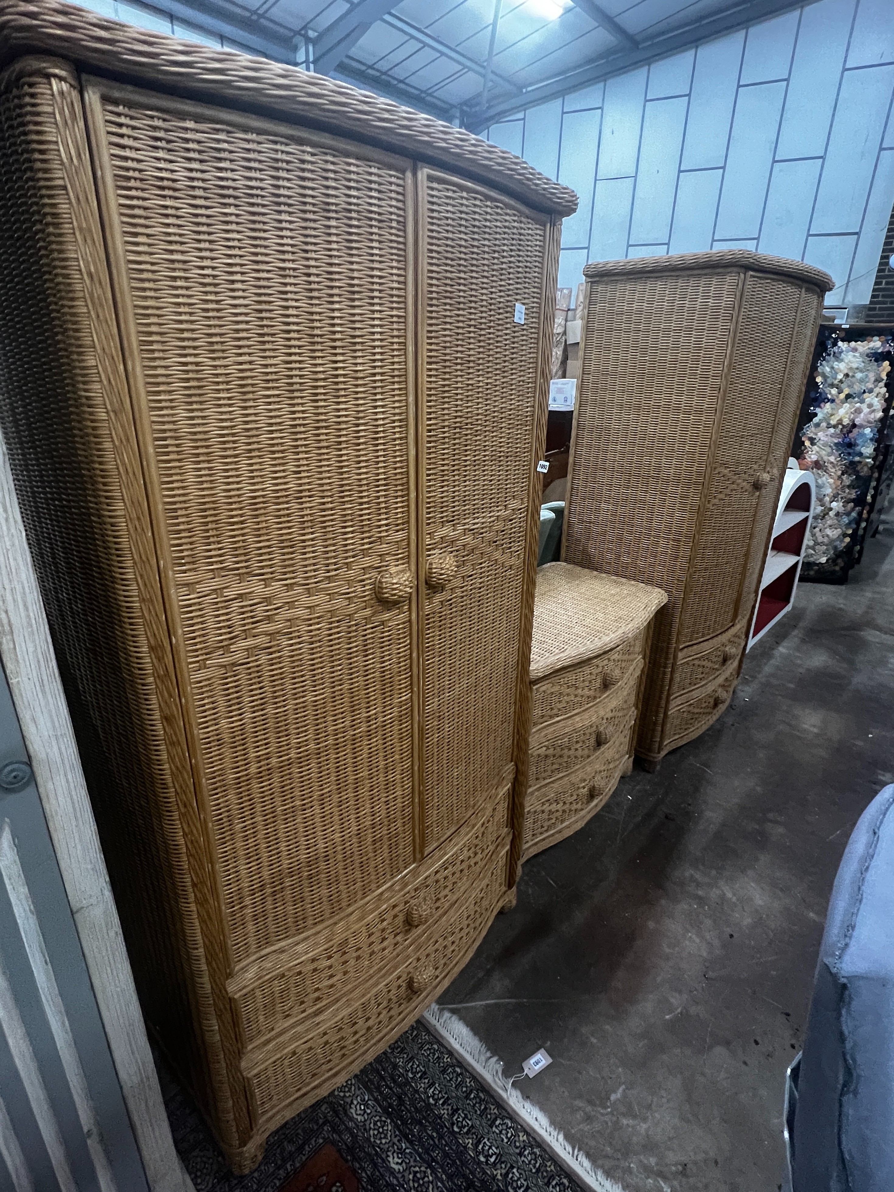A pair of Pier furniture bowfront rattan wardrobes, width 95cm, depth 58cm, height 184cm together with a matching three drawer chest